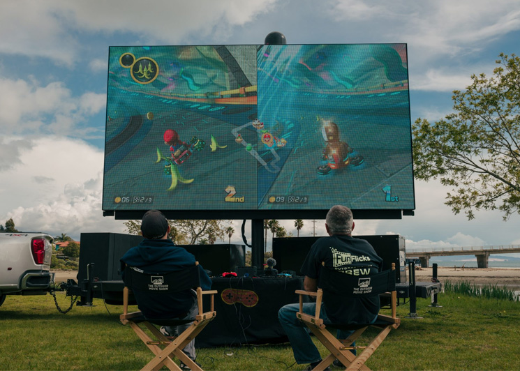 Matthew and Paul playing Mario Kart 8 on a FunFlicks LED screen