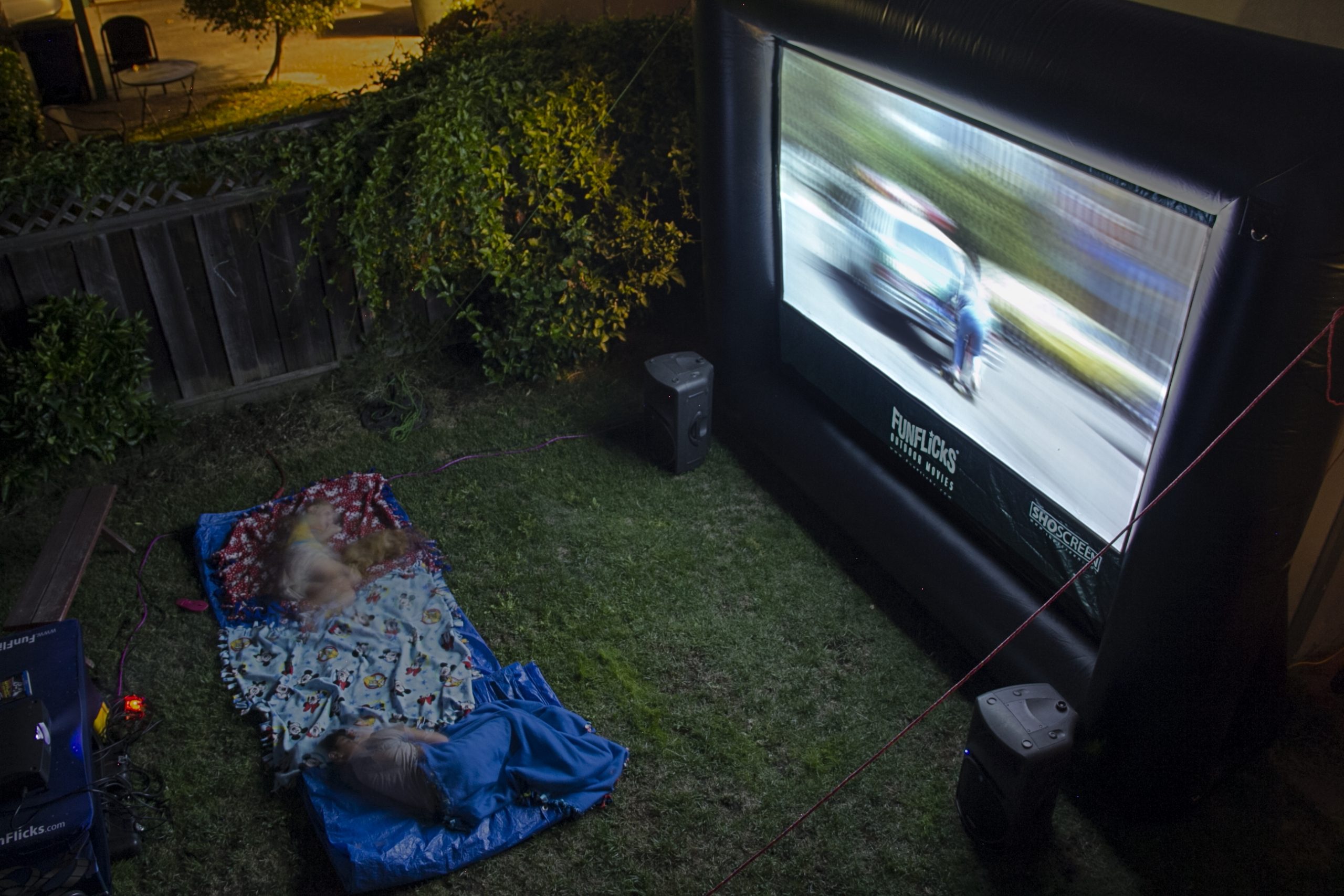 Family backyard movie party with an inflatable movie screen