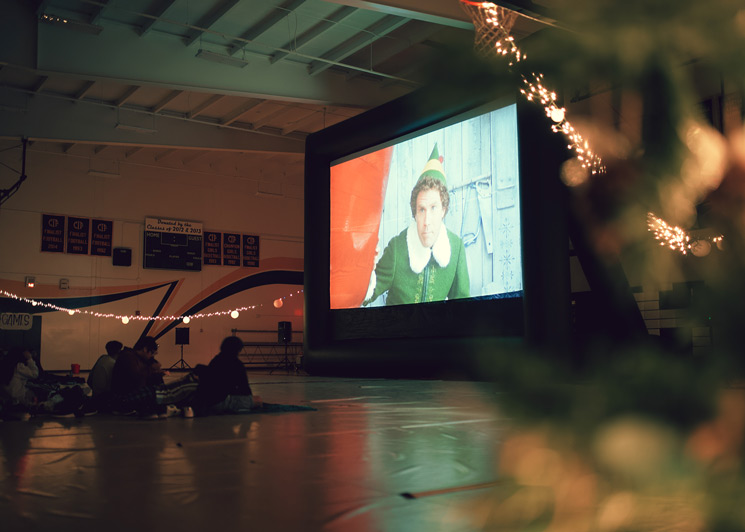 Indoor Christmas movie party at a school gym