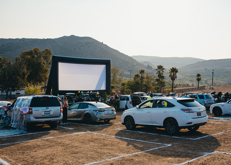 Drive-in concert with an inflatable projector screen display