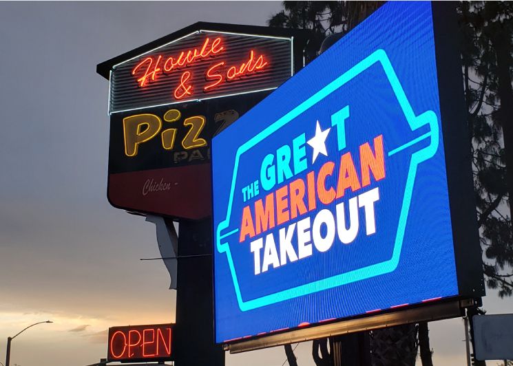 FunFlicks LED Trailer in front of a pizza place
