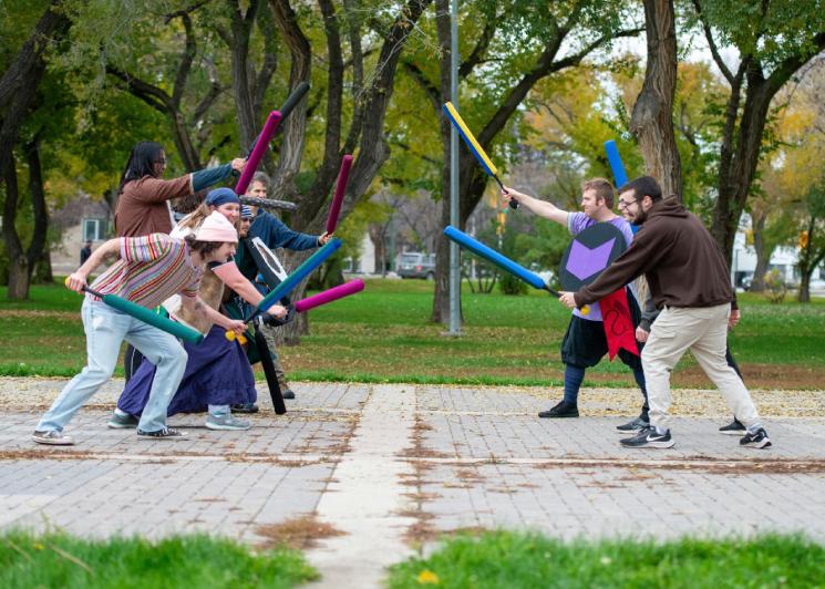 People lined up to engage in a foam sword fight
